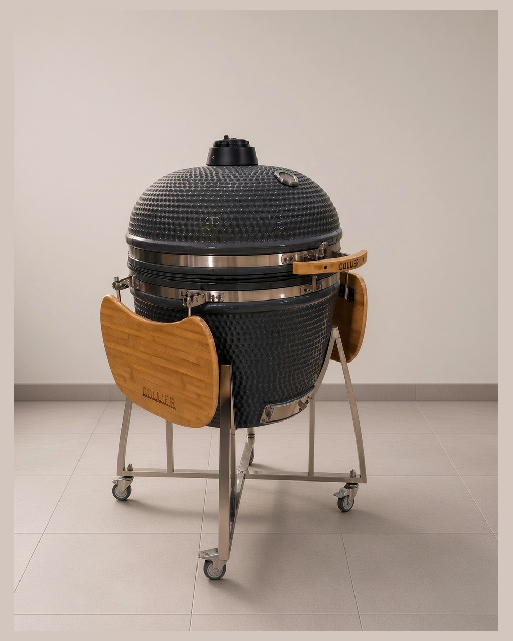 Collier ceramic kamado with the lid open, showing the stainless grate and bamboo side shelves